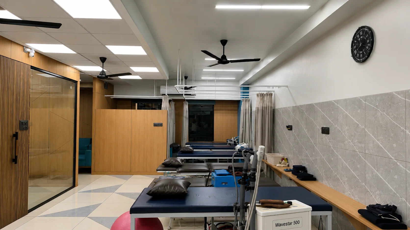 Treatment studio with therapy beds and rehabilitation equipment